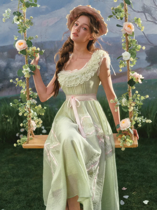Vintage-inspired green ribbon dress featuring layered lace neckline and airy silhouette, styled on a floral swing in a dreamy fairycore garden atmosphere.