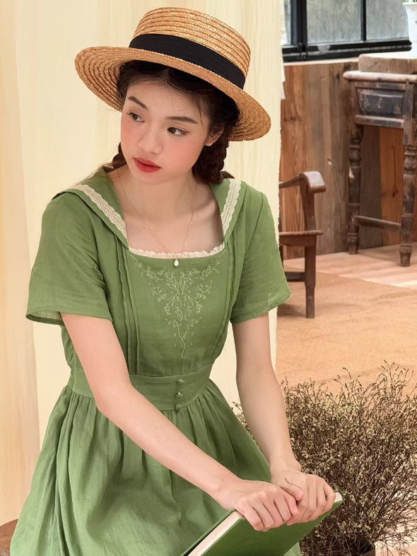 Lifestyle shot of a vintage-inspired green dress with embroidery, showcasing a fairytale aesthetic for a dreamy summer look.