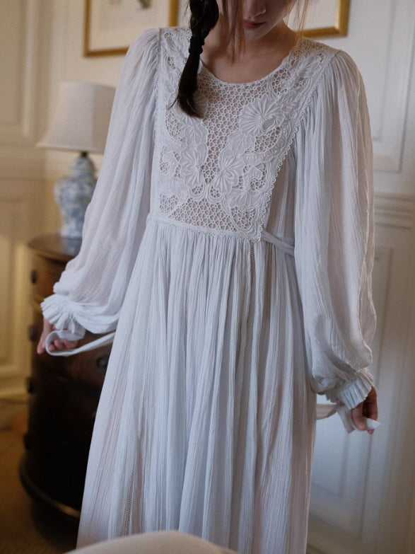 Close-up of embroidered lace bodice on white vintage night dress, delicate floral detailing and sheer pleated fabric