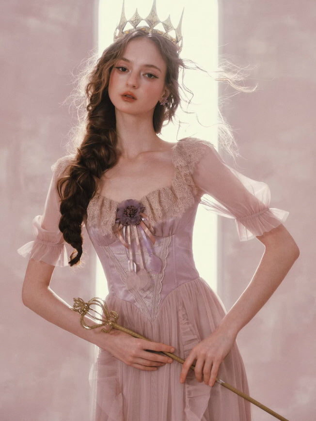 Elegant princess pink dress with lace bodice and sheer sleeves styled with crown and wand in soft pastel fairytale aesthetic