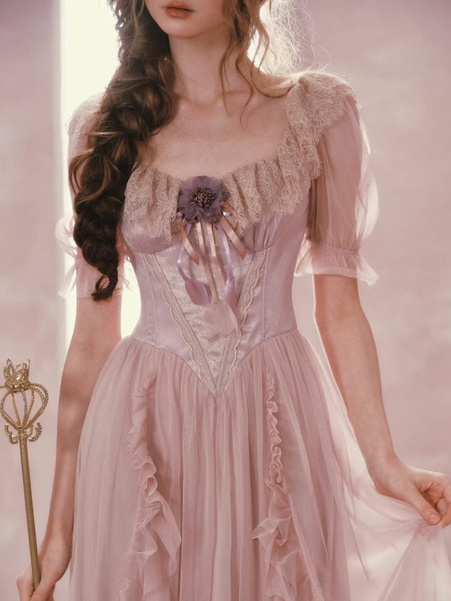 Vintage inspired lace corset bodice pink dress with floral ribbon detail, soft puff sleeves and romantic cottagecore aesthetic