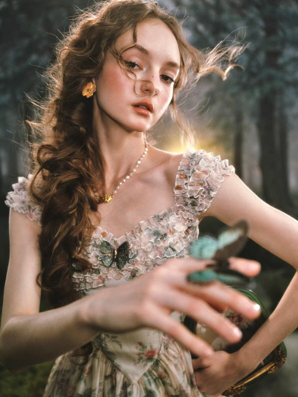 romantic floral cottagecore midi dress with ruffle neckline and butterfly detail in dreamy forest setting