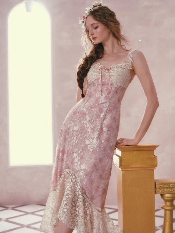 Elegant fairycore pink lace dress with flowing silhouette and lace hem, model leaning gracefully in romantic pastel setting