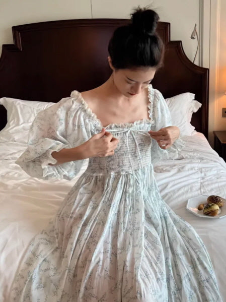 romantic cottagecore floral smocked dress hanging on hanger, soft sunlight vintage aesthetic