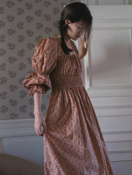 side view of vintage floral prairie dress with smocked waist and voluminous sleeves