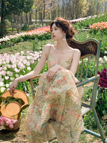 Romantic floral maxi dress with thin straps photographed in a tulip garden, feminine spring summer outfit