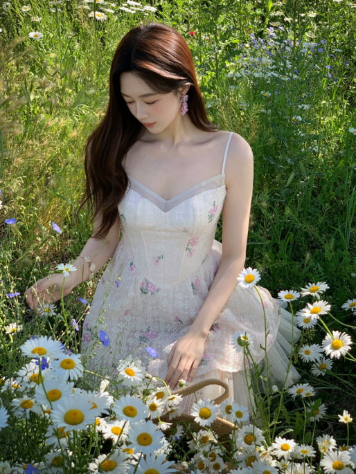 Fairycore ivory floral lace dress with corset bodice, spaghetti straps, and soft tulle hem in a sunny daisy field