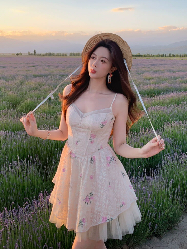 Ivory pink floral lace mini dress with corset-style bodice and layered tulle skirt, styled in a lavender field at sunset