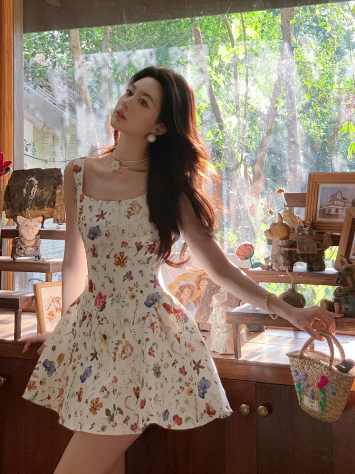 Ivory floral fairycore fit-and-flare mini dress with square neckline, styled with pearl accessories in a sunlit room