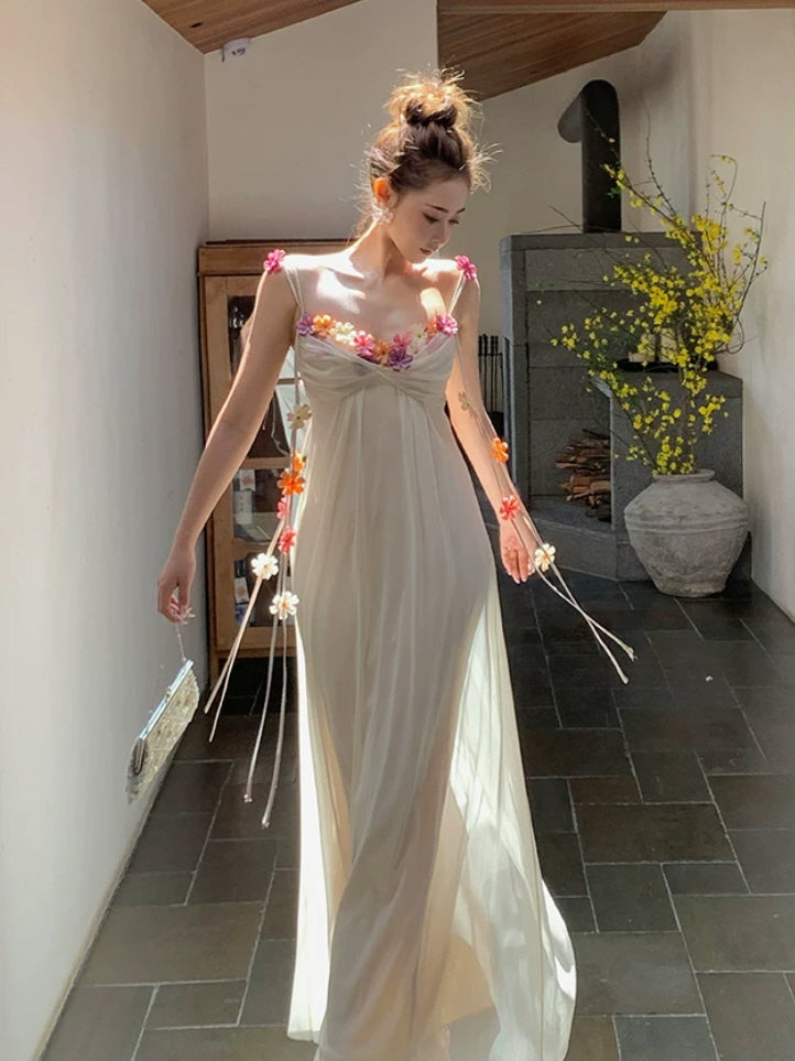 Fairycore summer dress with pastel floral decorations, thin straps, and ethereal flowing silhouette