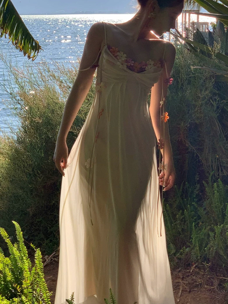 Ivory cottagecore fairy dress with sheer overlay, pastel flowers, and dreamy seaside styling
