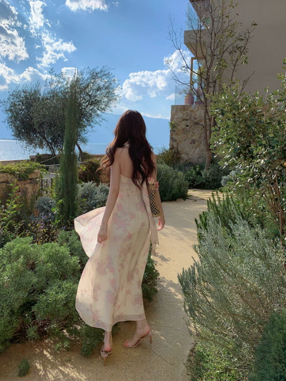 Fairycore pink floral maxi dress with open back and flowing silhouette by the sea