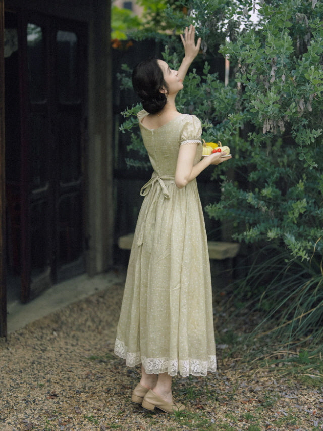 Back view of sage green cottagecore dress with waist tie and lace hem