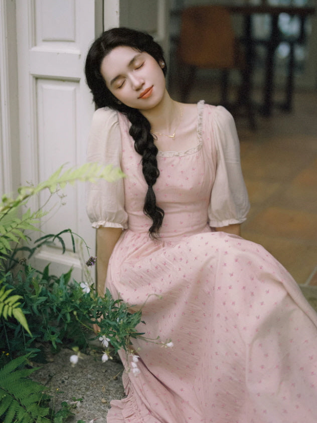 Romantic fairytale pink cottagecore maxi dress with delicate floral print and ruffled hem