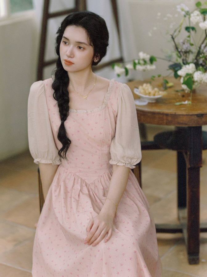 Vintage-inspired pink floral dress with square neckline and fitted bodice