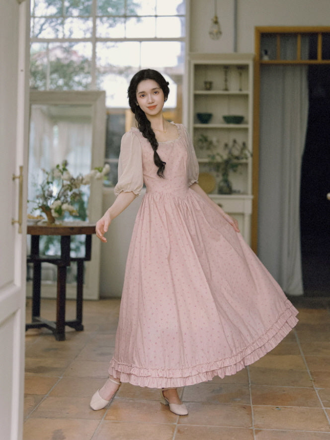 Pink cottagecore dress with tiny floral print, ruffle trim, and flowing skirt