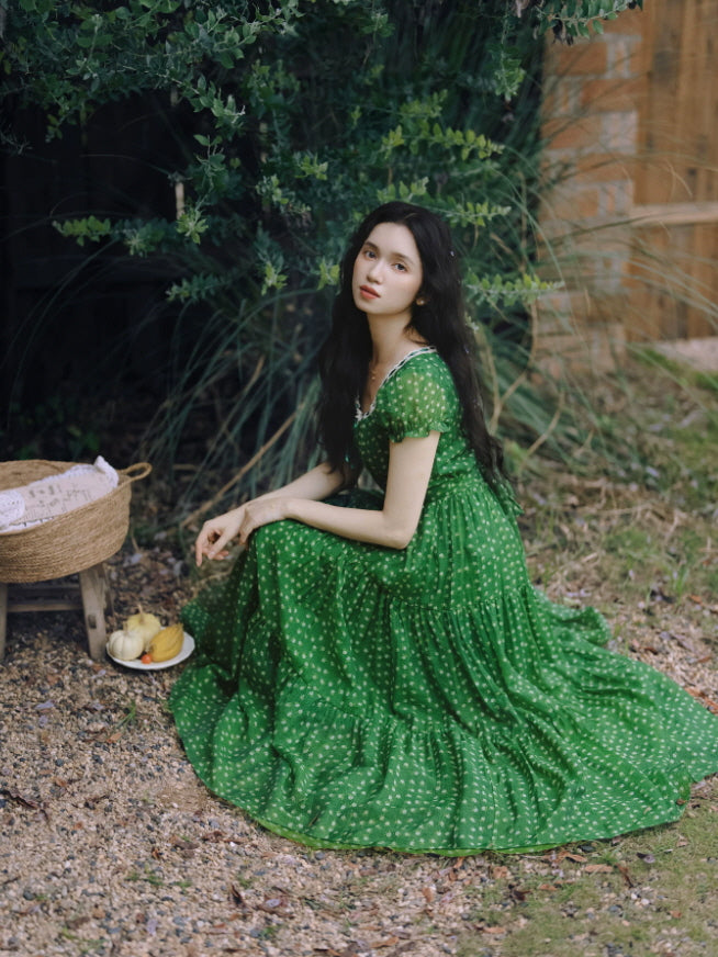 Green floral cottagecore maxi dress with tiered skirt and lace-trimmed neckline