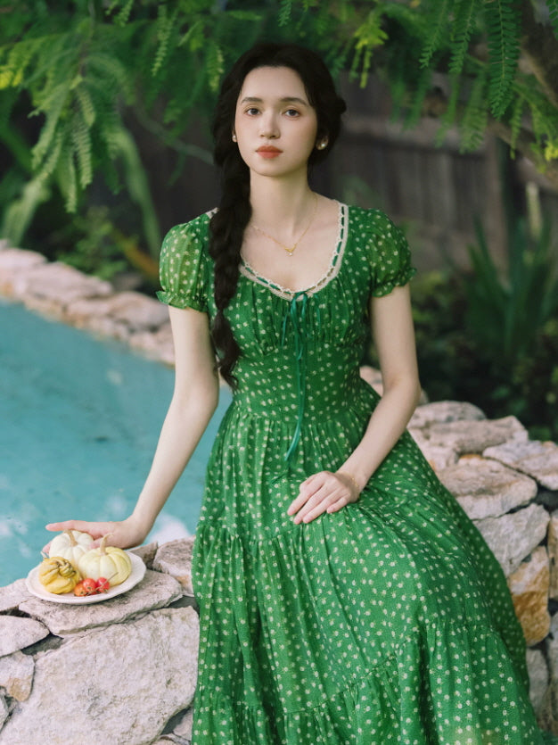 Vintage-inspired green prairie dress with puff sleeves and fitted waist