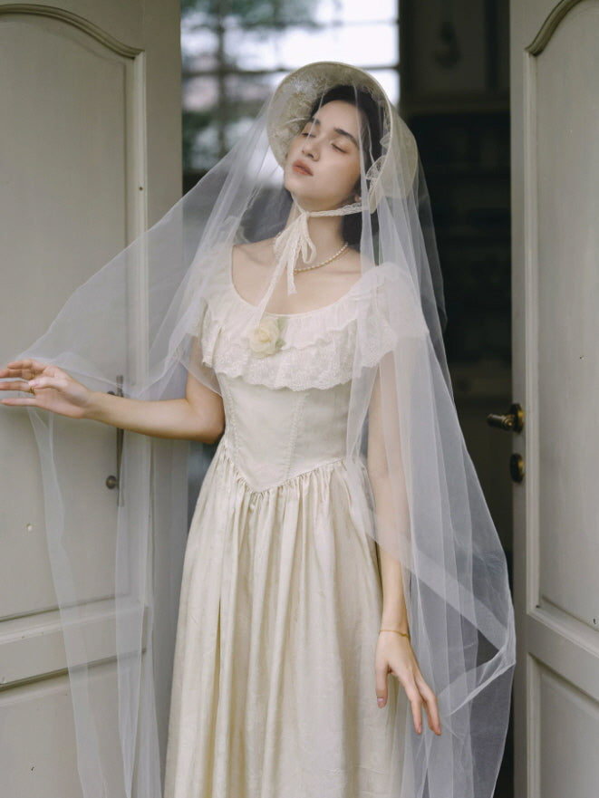Romantic ivory prairie dress with delicate lace collar and flower detail styled with a sheer vintage veil