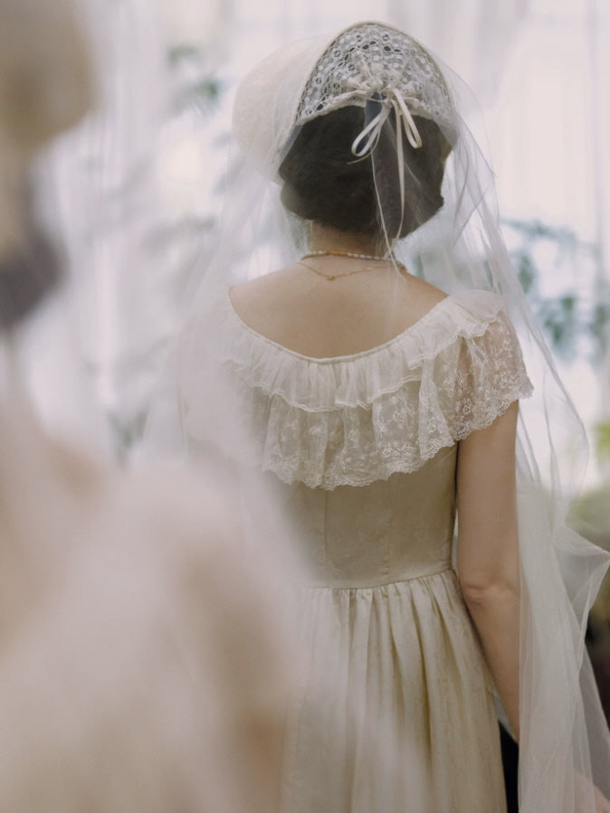 Back view of ivory fairycore maxi dress with layered lace ruffle neckline and softly gathered full skirt