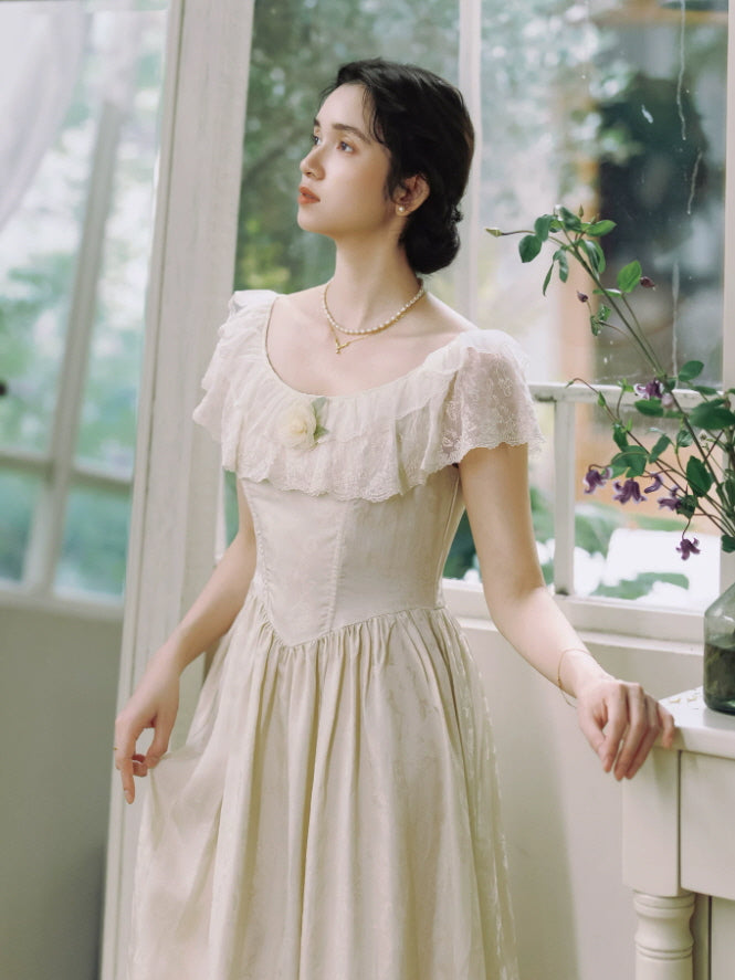 Elegant ivory fairycore maxi dress with lace trimmed scoop neckline, fitted waist and soft floral texture