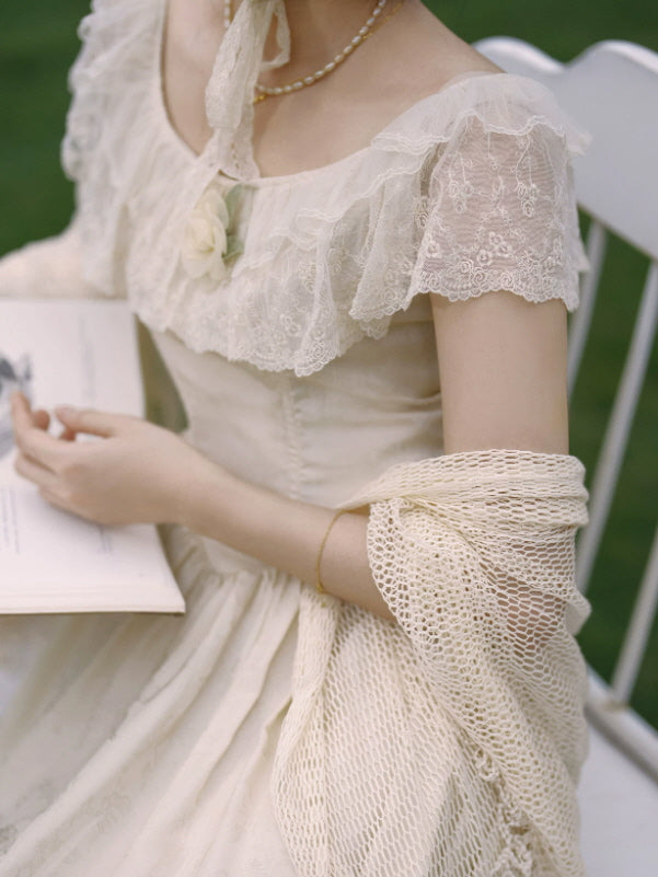 Close up of ivory lace prairie dress with embroidered flutter sleeves, floral applique and romantic corset inspired bodice