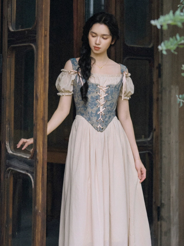 Romantic blue and beige corset dress with an off shoulder neckline, puff sleeves and flowing cottagecore silhouette