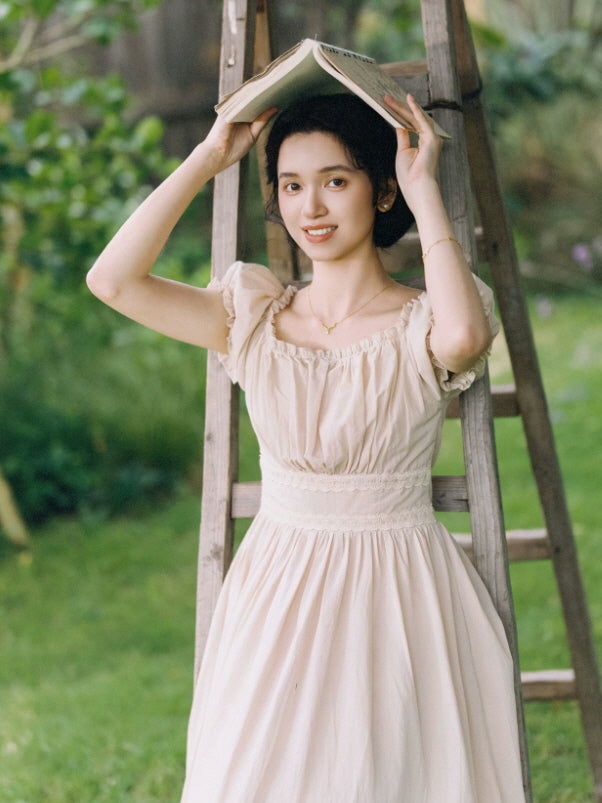 Soft beige fairycore dress with ruched bodice, fitted waist and flowing vintage inspired maxi skirt