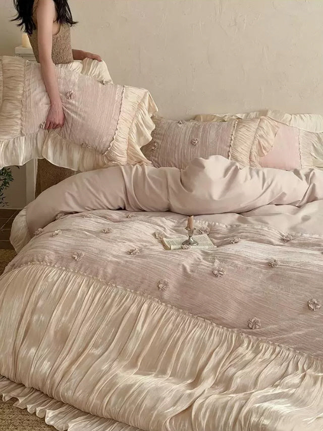 Princesscore bedding set featuring pale blush fabric, layered satin ruffles, and tiny floral accents for a romantic vintage bedroom