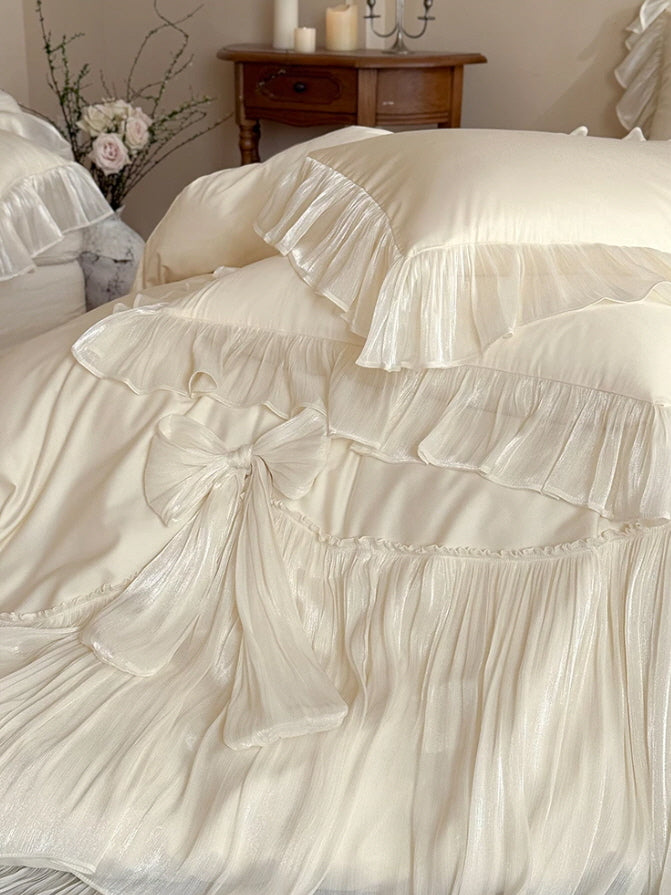 Vintage-inspired ivory bedding set with romantic bows, ruffled edges, and feminine cottagecore styling