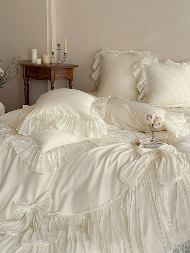 Romantic ivory bedding set with gathered skirt trim and elegant decorative bows