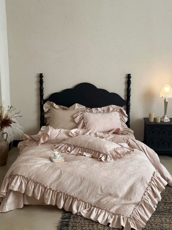 Blush pink floral ruffle bedding set with vintage-inspired trim and romantic feminine styling