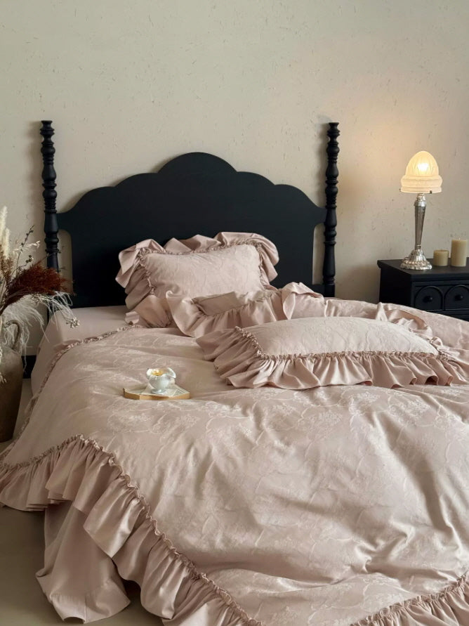 Romantic pink ruffle bedding set with subtle botanical texture and elegant vintage details