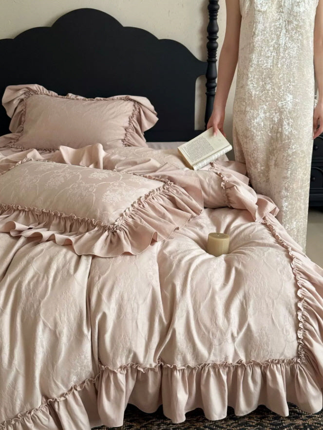 Blush floral bedding with layered ruffle pillow shams and a soft princesscore aesthetic