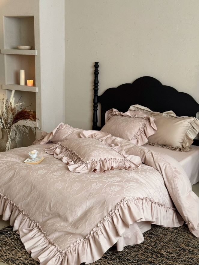 Vintage-inspired dusty pink bedding set with floral texture and graceful gathered trim