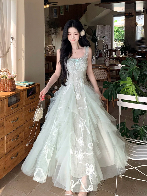 Mint green cottagecore princess dress with delicate lace embroidery, bow motifs and dreamy layered tulle