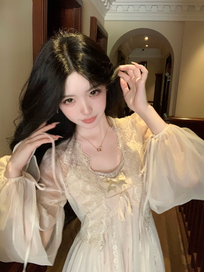Close up of cream princesscore nightgown with scalloped lace neckline, satin bow and sheer balloon sleeves