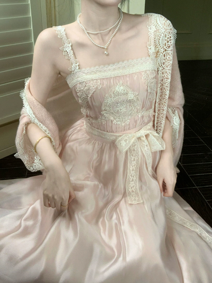Close-up of blush pink lace dress with embroidered bodice, floral lace straps and satin ribbon waist