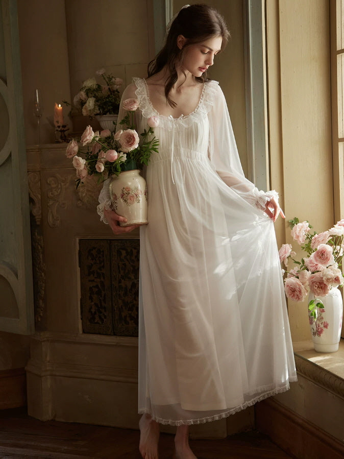 White vintage nightgown with ruffled lace neckline, gathered waist and delicate sheer sleeves
