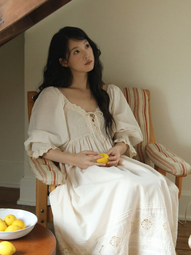 Long ivory cotton nightgown with smocked lace bodice and delicate embroidered hem detail