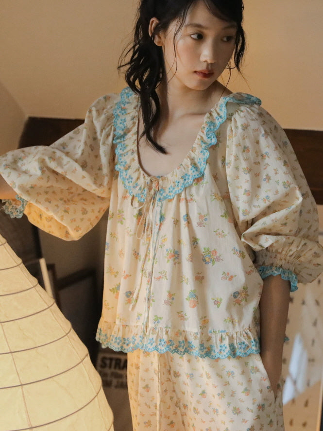 Romantic floral pajama blouse with puff sleeves, front buttons and blue ruffle trim paired with matching pants