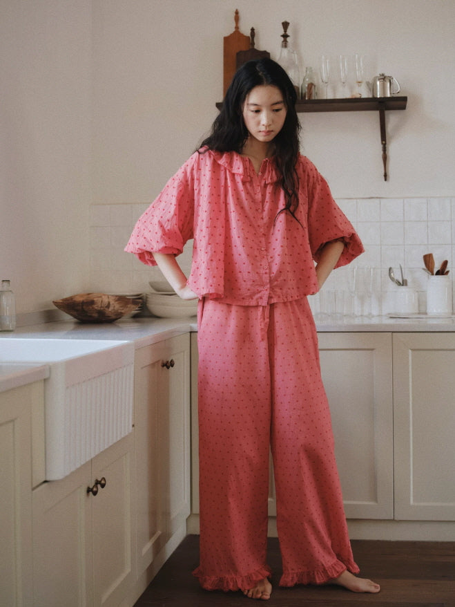 Relaxed pink cotton pajama set with romantic ruffle details, loose sleeves and comfortable wide leg silhouette