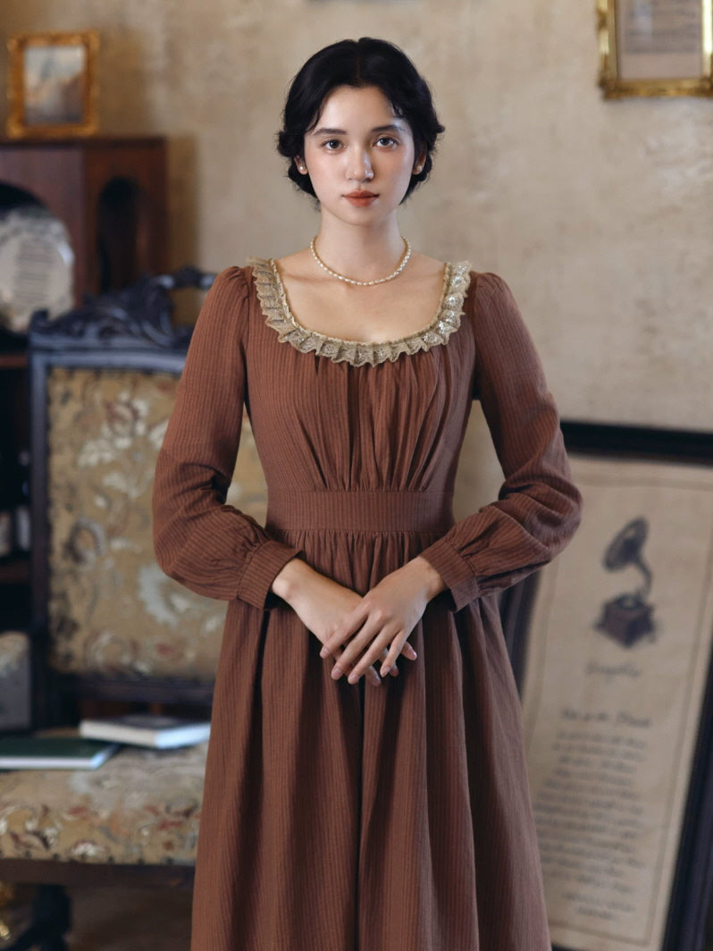 Brown vintage cottagecore maxi dress with lace-trimmed square neckline and long sleeves in an antique-inspired interior