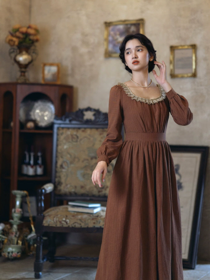 Long sleeve brown maxi dress with delicate beige lace trim and flowing gathered skirt