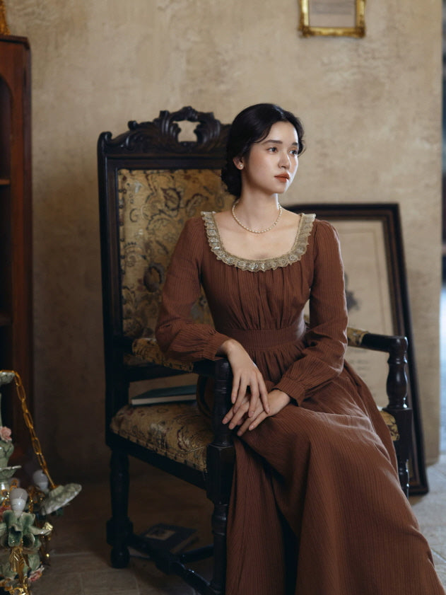 Elegant brown cottagecore maxi dress with long sleeves, defined waist and romantic lace trim
