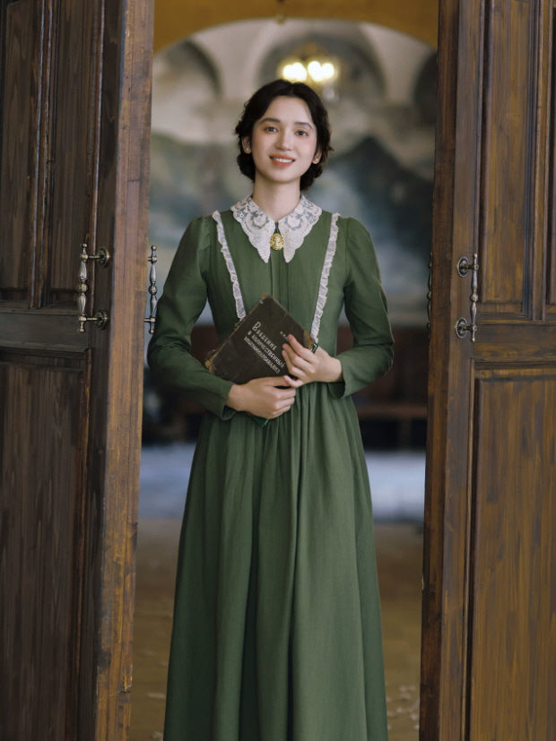 Full-length green vintage maxi dress with lace collar, long sleeves and softly gathered skirt