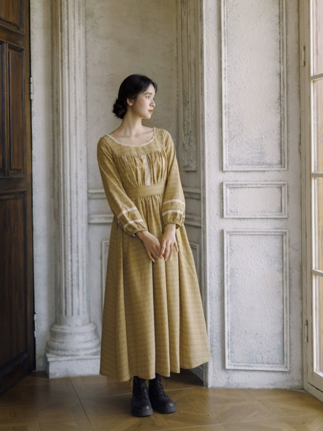 Mustard check vintage maxi dress with square neckline, lace trim and long sleeves in a romantic antique interior