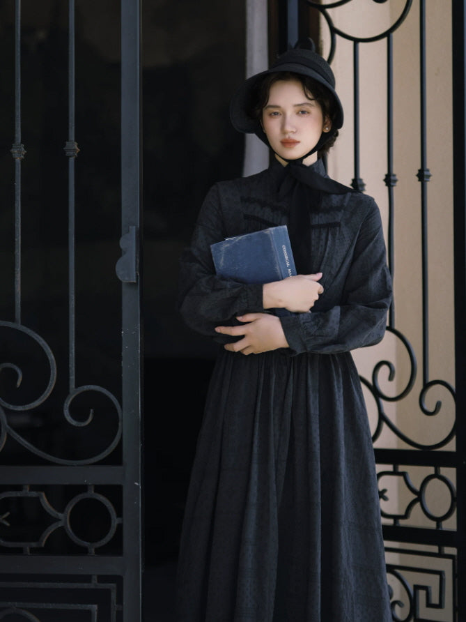 Black vintage maxi dress with high neckline, long sleeves and gathered bodice styled with a bonnet