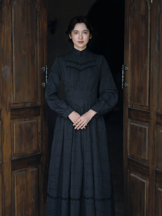 Women’s black vintage long dress with high collar, fitted bodice and flowing full-length skirt