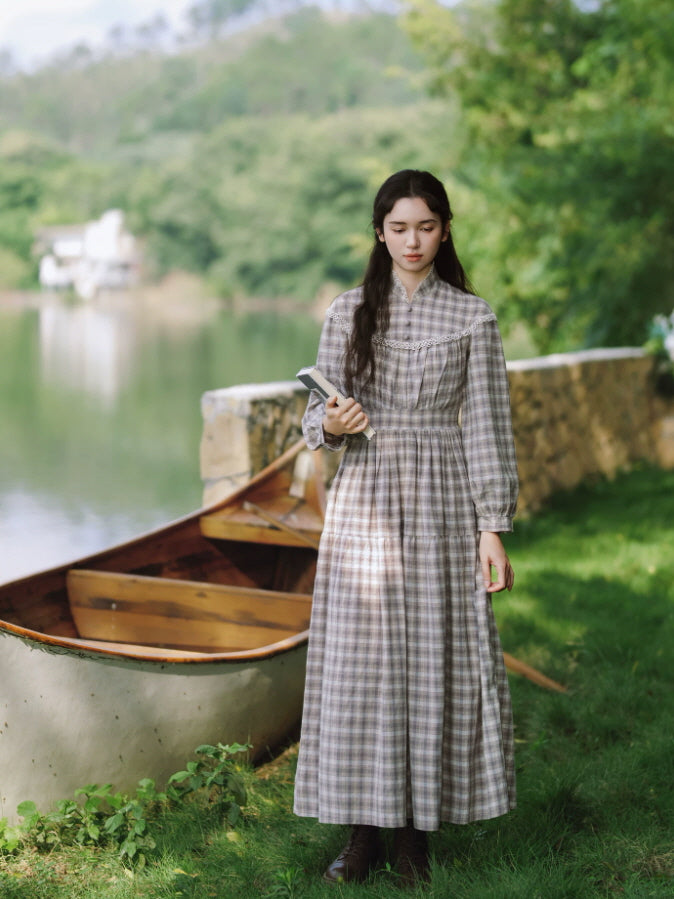 Women’s gray plaid maxi dress with fitted waist, long sleeves and romantic cottagecore silhouette by the lake